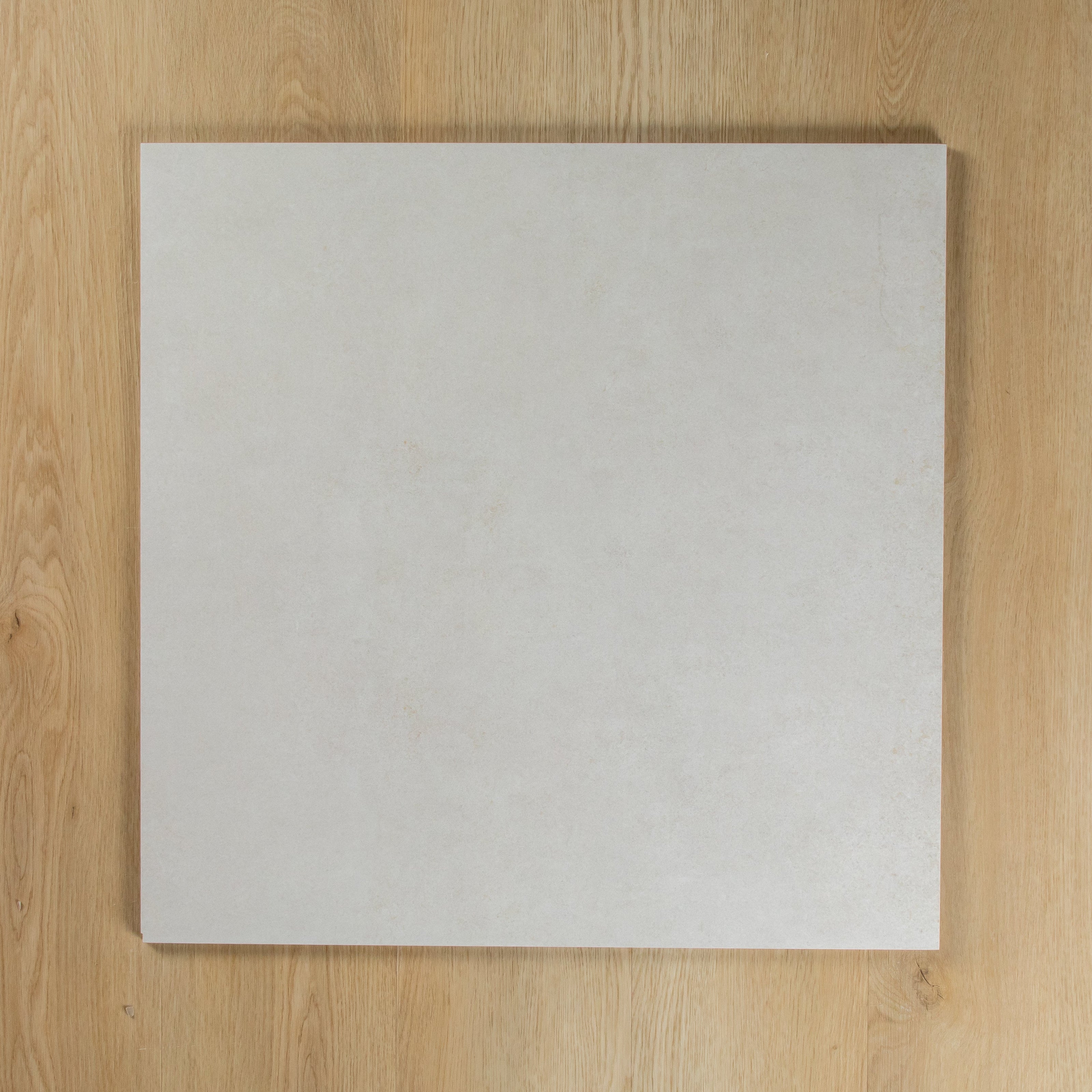 Boston Bianco Matte square tile on a wooden surface