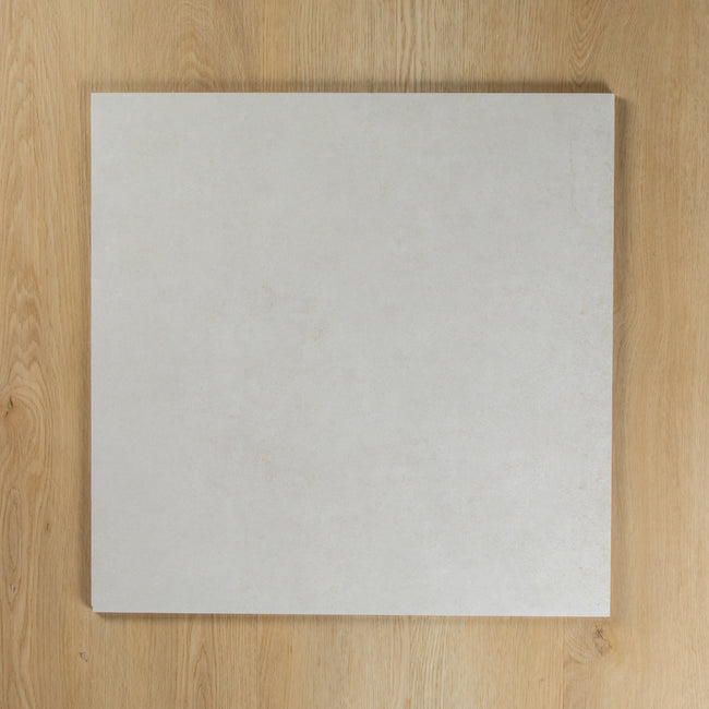 Boston Bianco Matte square tile on a wooden surface